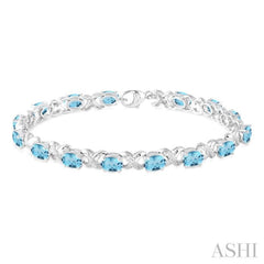 7x5 MM Oval Cut Blue Topaz and 1/20 Ctw Round Cut Diamond Fashion Bracelet in Sterling Silver